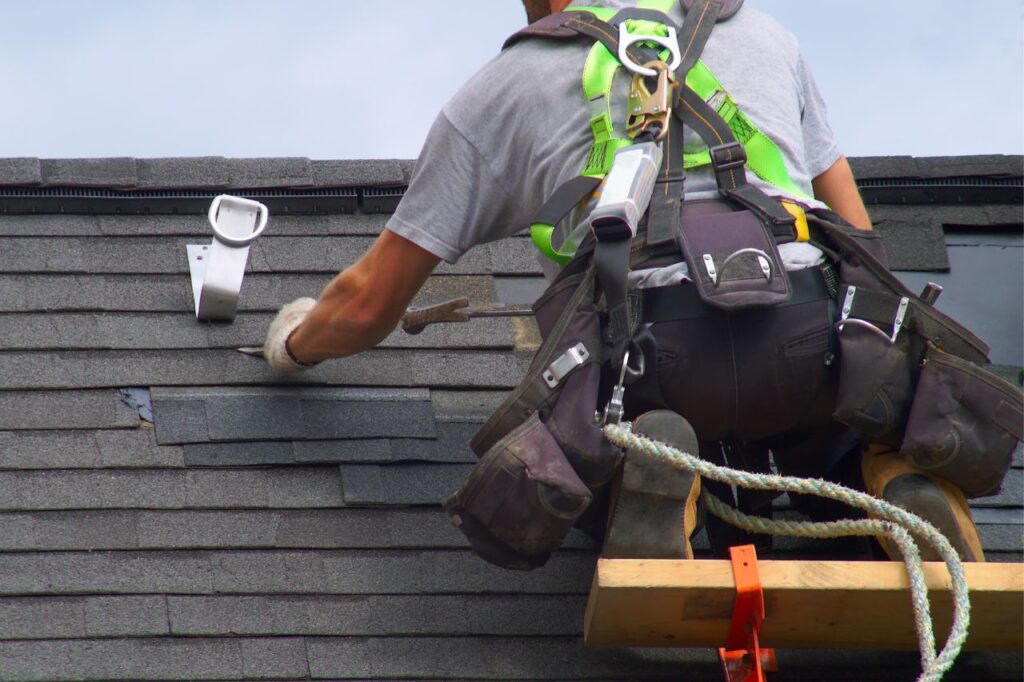 man working on roof